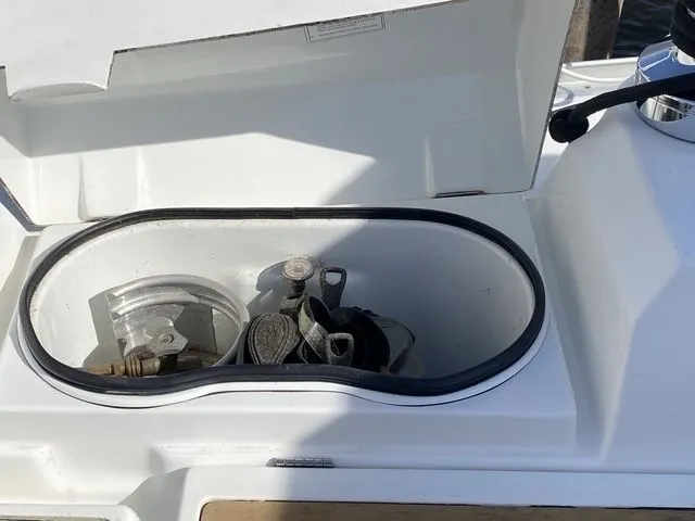 Axis Mundi Yacht Photos Pics Open storage compartment on a 2002 Beneteau 393 sailboat deck.