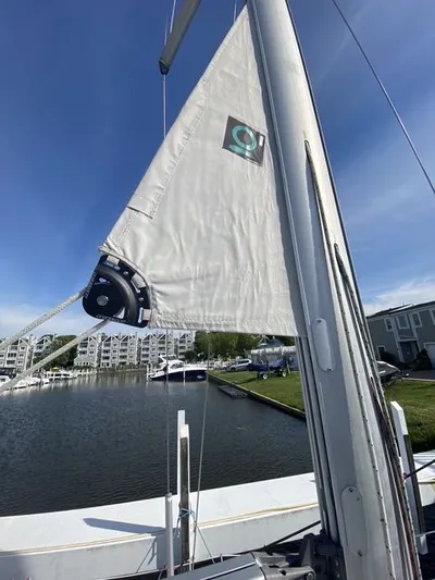Axis Mundi Yacht Photos Pics Sailboat mast and sail of a 2002 Beneteau 393 docked at a marina.