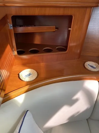 Axis Mundi Yacht Photos Pics Interior of 2002 Beneteau 393 yacht with wooden cabinetry and seating area.