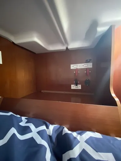 Axis Mundi Yacht Photos Pics Interior of 2002 Beneteau 393 sailboat showing wooden cabinetry and control panel.