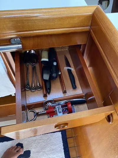 Axis Mundi Yacht Photos Pics Wooden drawer with utensils and tools on a 2002 Beneteau 393 yacht.