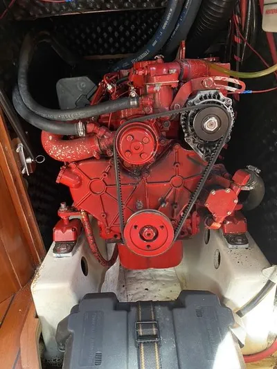 Axis Mundi Yacht Photos Pics Red engine of a 2002 Beneteau 393 sailboat, showcasing mechanical components.