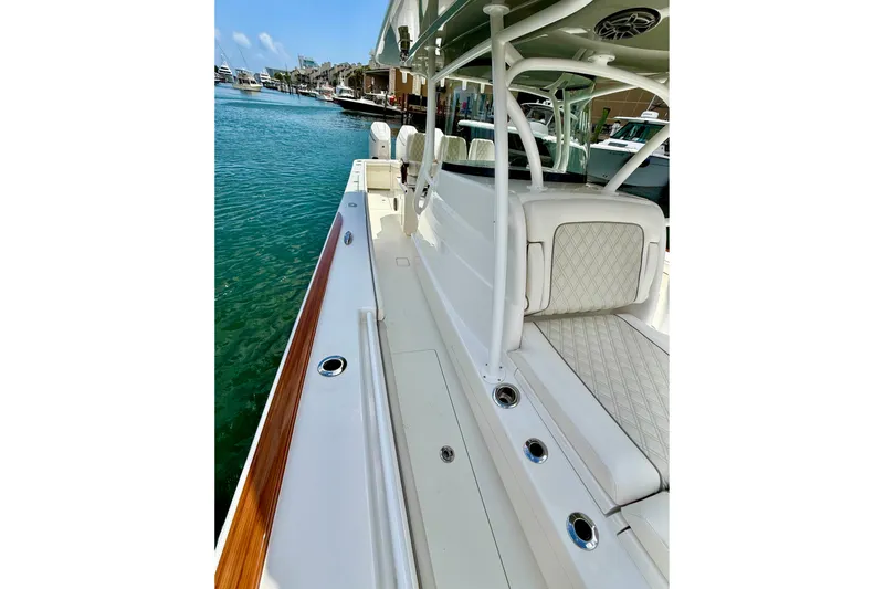 Salty Dogs Yacht Photos Pics 2024 Valhalla Boatworks V-37, sleek design, luxurious seating, docked in marina.