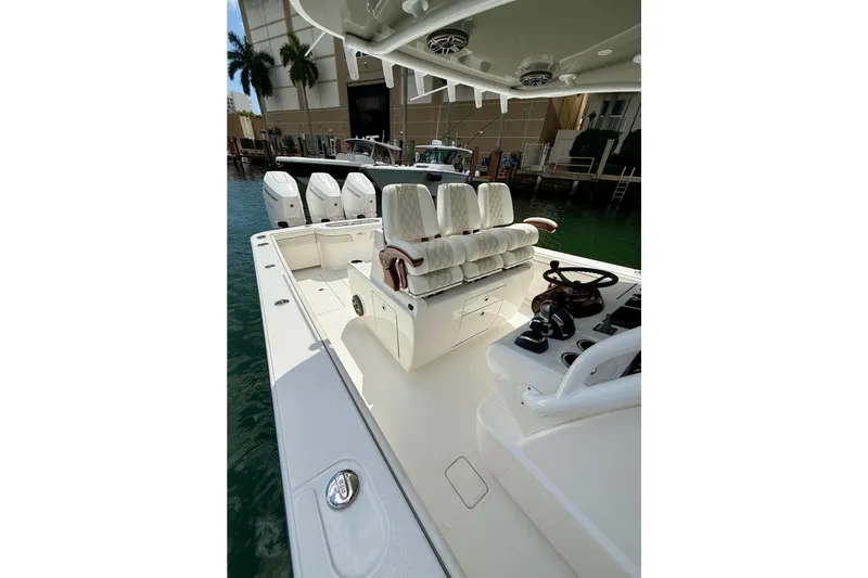 Salty Dogs Yacht Photos Pics 2024 Valhalla Boatworks V-37 with luxurious seating and sleek design in marina setting.