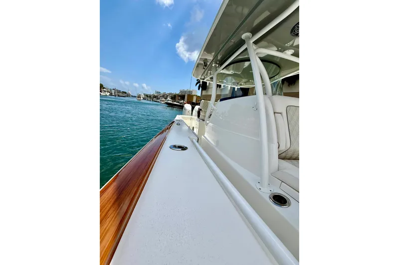 Salty Dogs Yacht Photos Pics 2024 Valhalla Boatworks V-37, sleek design, docked on calm waters under blue sky.