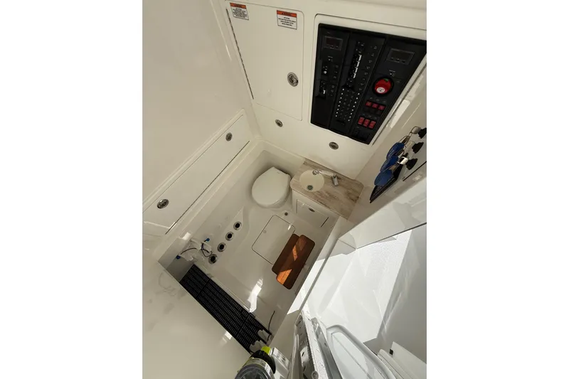 Salty Dogs Yacht Photos Pics 2024 Valhalla Boatworks V-37 interior cabin with control panel and compact amenities.