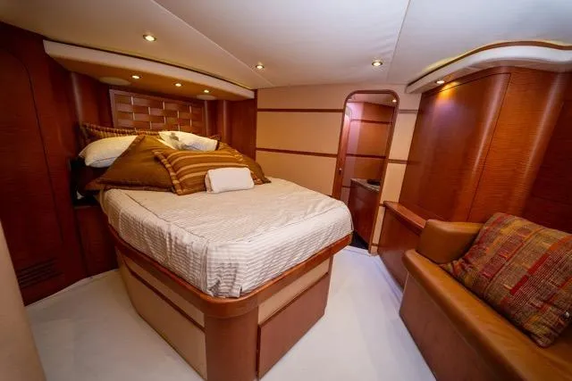  Yacht Photos Pics Luxurious 1997 Garlington Convertible yacht interior with cozy bedroom and elegant wood finishes.