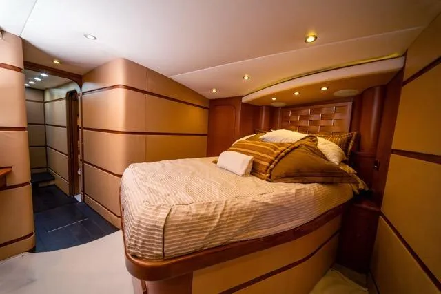  Yacht Photos Pics Luxurious bedroom interior of a 1997 Garlington Convertible yacht with elegant wood accents.