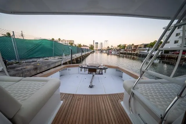  Yacht Photos Pics 1997 Garlington Convertible yacht with spacious deck, docked in a serene marina setting.