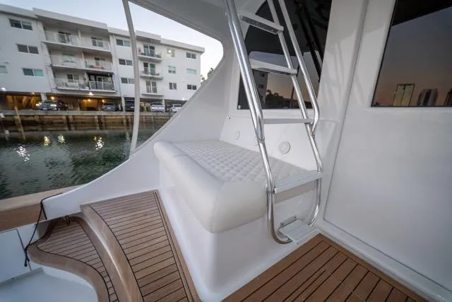  Yacht Photos Pics 1997 Garlington Convertible yacht with teak deck and cushioned seating near marina.