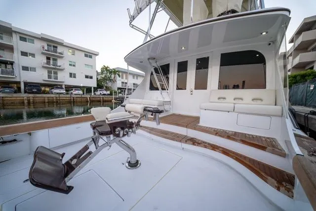  Yacht Photos Pics 1997 Garlington Convertible yacht with spacious deck and seating, docked near waterfront apartments.