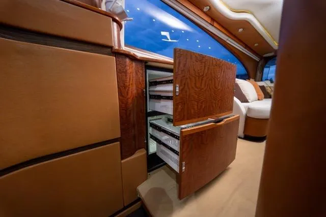  Yacht Photos Pics Luxurious 1997 Garlington Convertible interior with open wooden cabinets and plush seating.