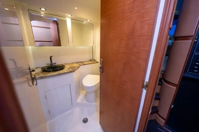  Yacht Photos Pics Luxurious bathroom in 1997 Garlington Convertible yacht with granite countertop and modern fixtures.