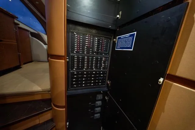  Yacht Photos Pics Electrical panel inside a 1997 Garlington Convertible yacht, showcasing circuit breakers and controls.