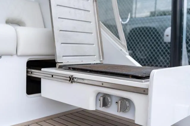  Yacht Photos Pics 1997 Garlington Convertible boat with built-in grill and seating area.