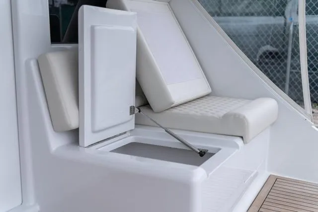  Yacht Photos Pics 1997 Garlington Convertible boat interior with open storage compartment and cushioned seating.