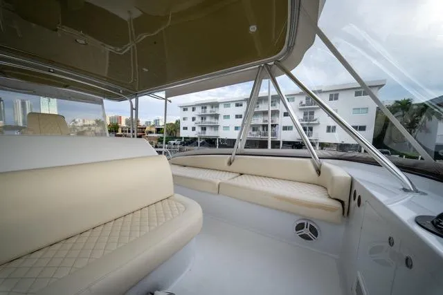  Yacht Photos Pics Luxurious 1997 Garlington Convertible yacht interior with beige seating and cityscape view.