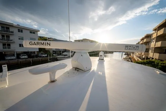  Yacht Photos Pics 1997 Garlington Convertible boat with Garmin xHD2 radar, docked near waterfront buildings at sunset.