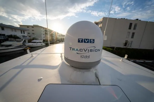  Yacht Photos Pics 1997 Garlington Convertible boat with TracVision TV5 satellite dome under a clear sky.
