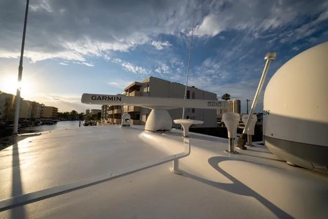  Yacht Photos Pics Rooftop view of 1997 Garlington Convertible boat with Garmin equipment under a blue sky.