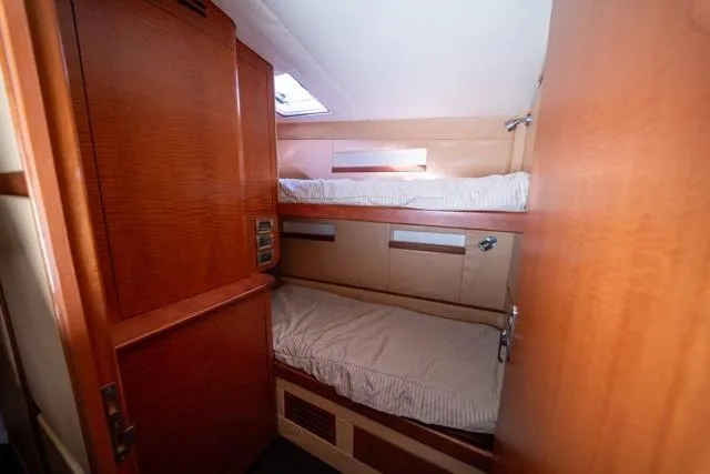  Yacht Photos Pics 1997 Garlington Convertible yacht interior with cozy bunk beds and wooden finish.