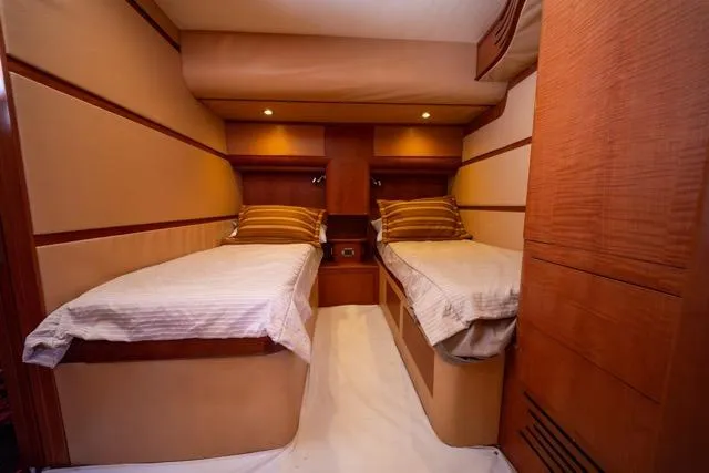  Yacht Photos Pics Interior of 1997 Garlington Convertible yacht with twin beds and wooden paneling.
