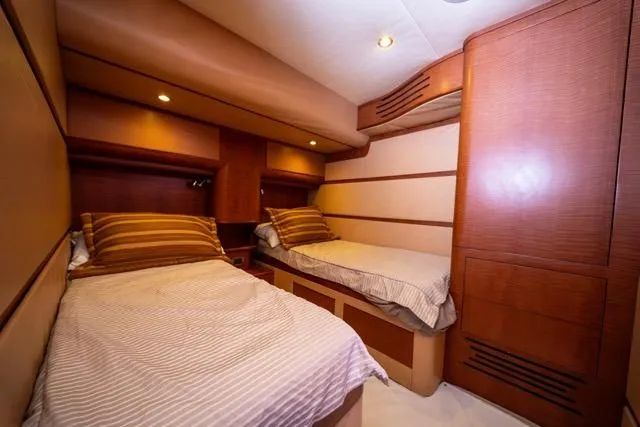  Yacht Photos Pics Luxurious 1997 Garlington Convertible yacht cabin with twin beds and warm wood accents.