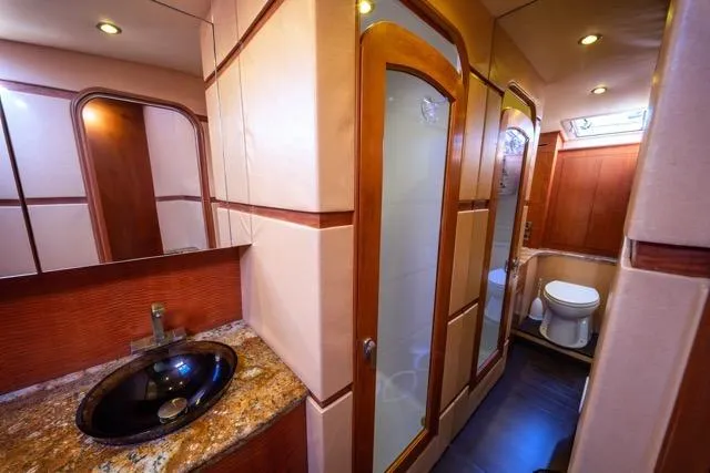  Yacht Photos Pics Luxurious bathroom interior of a 1997 Garlington Convertible yacht with modern fixtures.