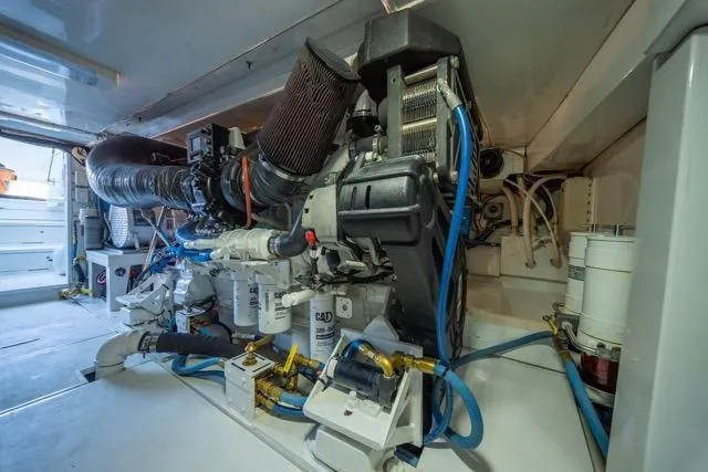  Yacht Photos Pics Engine room of a 1997 Garlington Convertible boat, showcasing complex machinery and components.