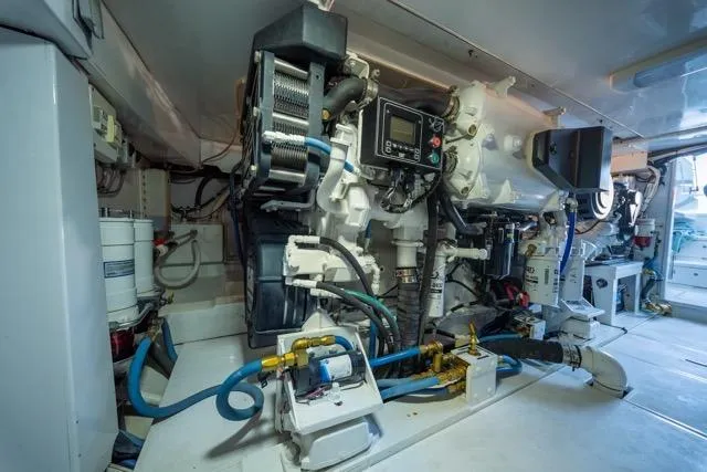 Yacht Photos Pics Engine room of a 1997 Garlington Convertible boat, showcasing complex machinery and equipment.
