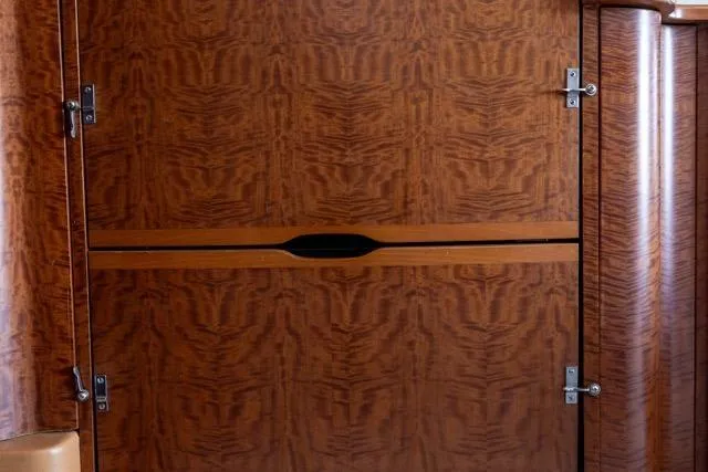  Yacht Photos Pics Wooden interior paneling of a 1997 Garlington Convertible, featuring intricate grain patterns.