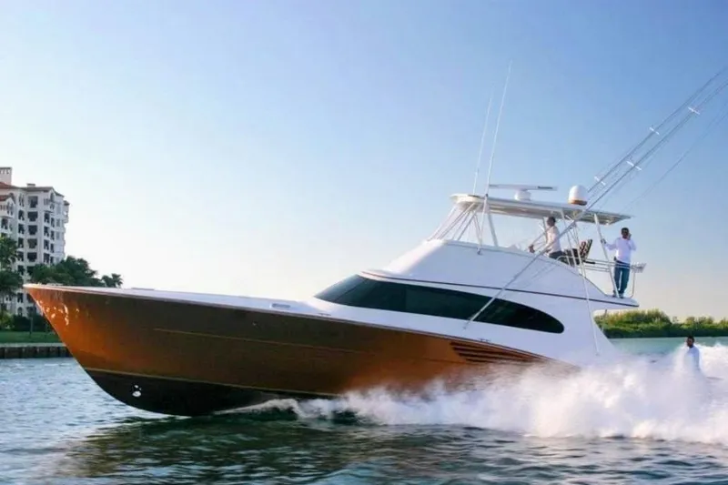  Yacht Photos Pics 1997 Garlington sport fish convertible yacht cruising on water, with people on deck.