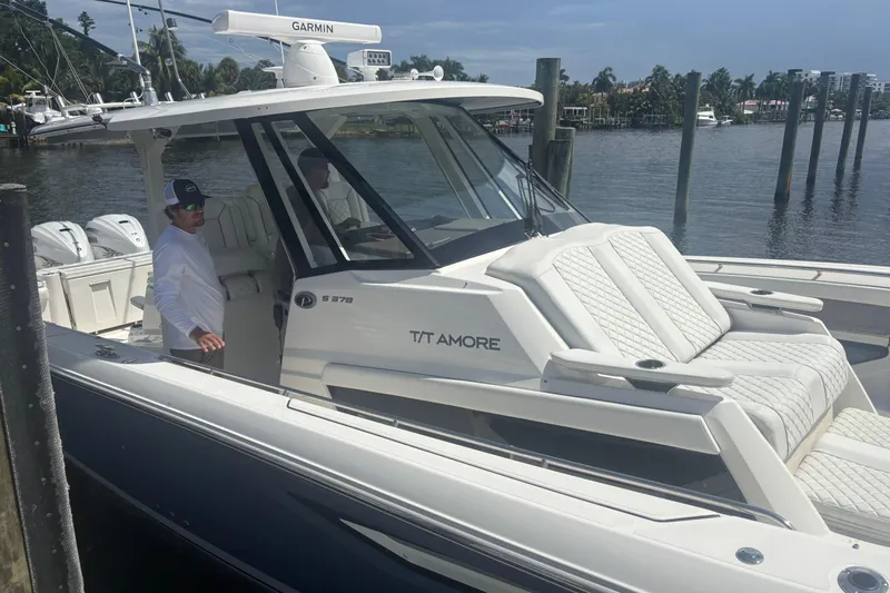  Yacht Photos Pics 2021 Pursuit S 378 Sport boat docked, featuring luxurious seating and modern design.