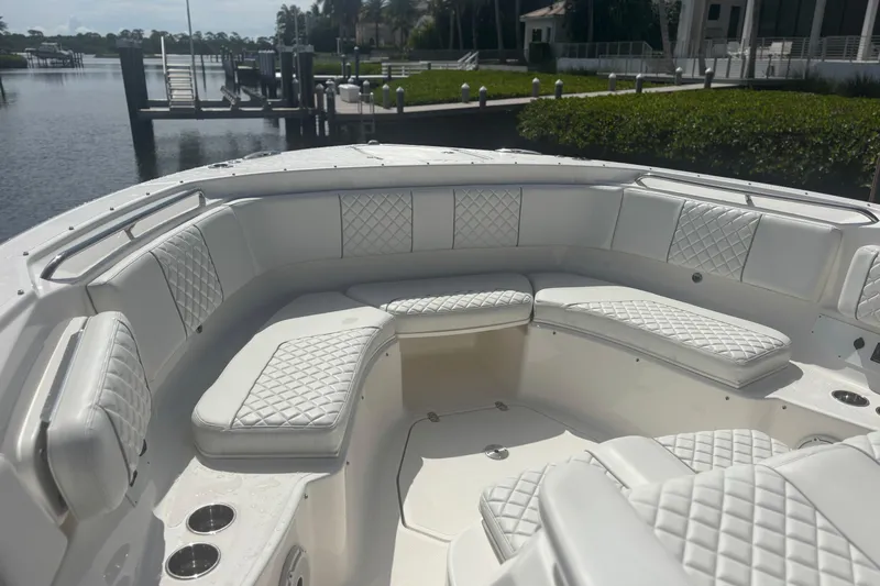  Yacht Photos Pics Luxurious seating on 2021 Pursuit S 378 Sport boat, docked by serene waterfront.