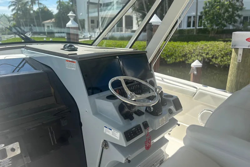  Yacht Photos Pics 2021 Pursuit S 378 Sport boat helm with steering wheel and controls.