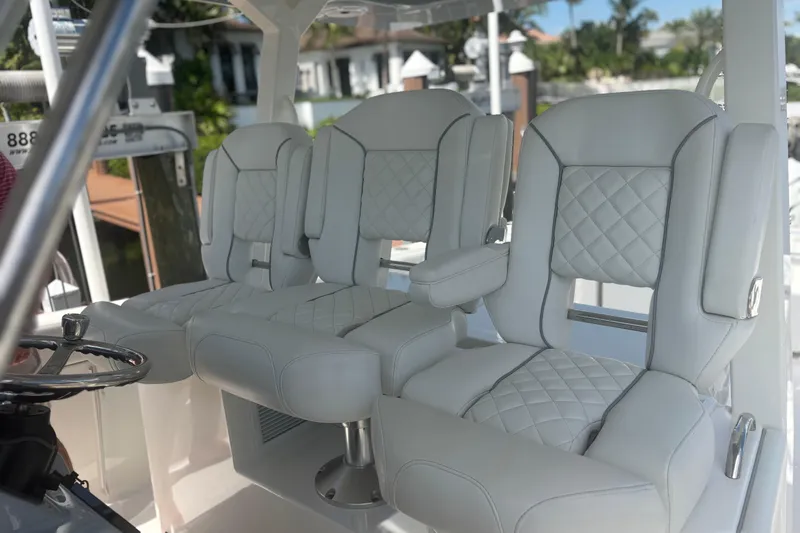  Yacht Photos Pics Luxurious seating on 2021 Pursuit S 378 Sport boat, featuring elegant white upholstery.