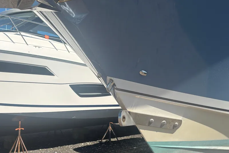  Yacht Photos Pics 2021 Pursuit S 378 Sport boat hulls in dry dock, side view.