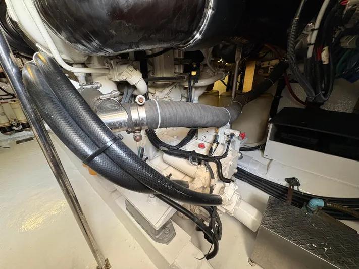 Obelix Yacht Photos Pics Engine room of a 2006 Riviera 60 Flybridge yacht, showcasing mechanical components and hoses.