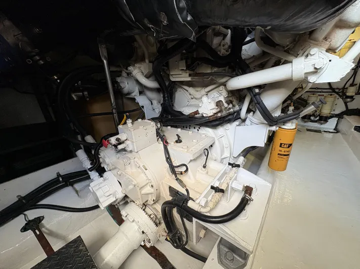 Obelix Yacht Photos Pics Engine room of a 2006 Riviera 60 Flybridge yacht, showcasing mechanical components and wiring.