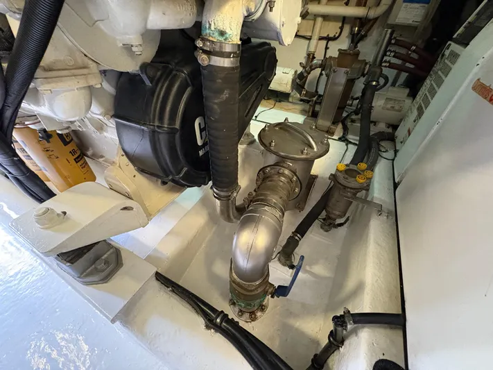 Obelix Yacht Photos Pics Engine room of 2006 Riviera 60 Flybridge yacht, showcasing mechanical components and piping.