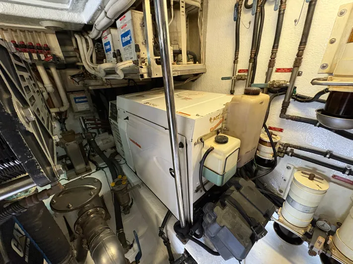 Obelix Yacht Photos Pics Engine room of a 2006 Riviera 60 Flybridge yacht, showcasing mechanical equipment and piping.