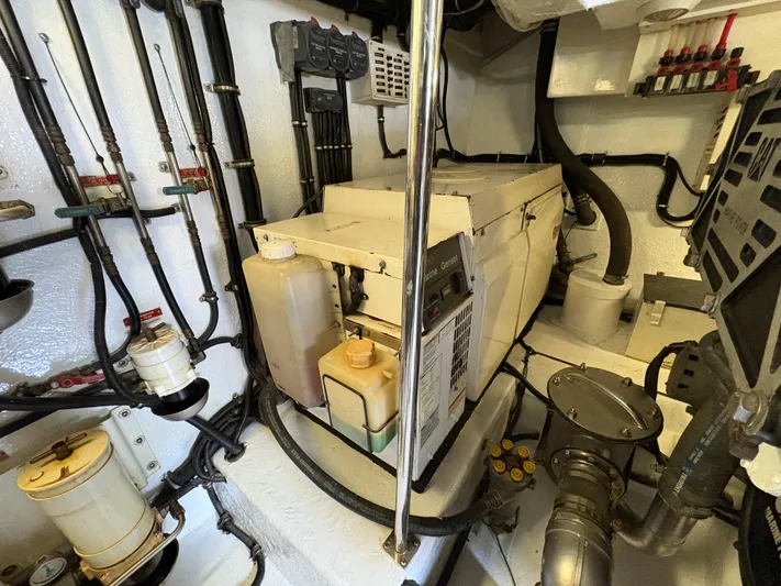 Obelix Yacht Photos Pics Engine room of a 2006 Riviera 60 Flybridge yacht, showcasing mechanical components and wiring.