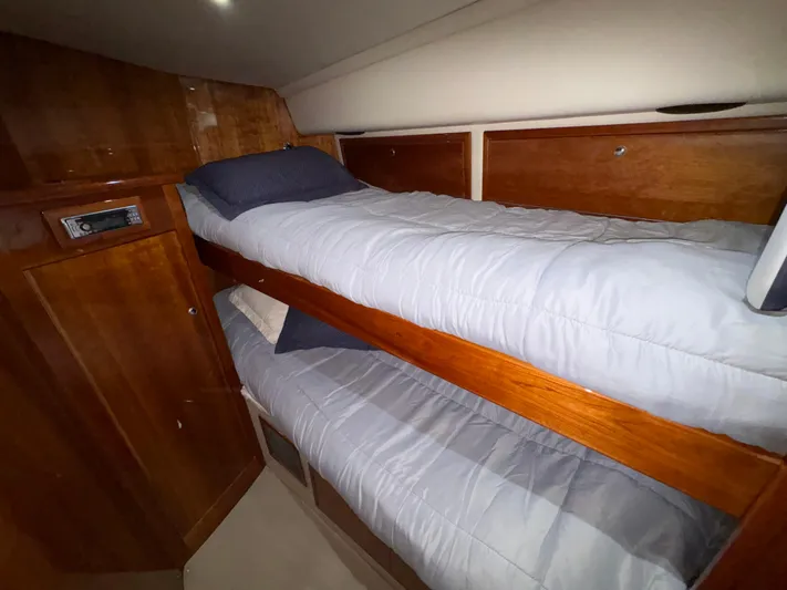 Obelix Yacht Photos Pics Bunk beds in 2006 Riviera 60 Flybridge yacht cabin with wooden interior.