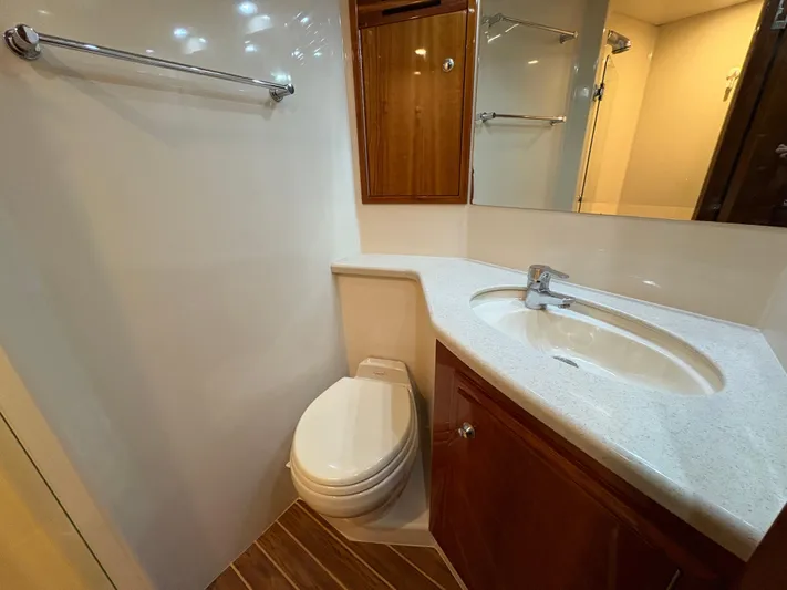 Obelix Yacht Photos Pics Bathroom interior of 2006 Riviera 60 Flybridge yacht with sink and toilet.