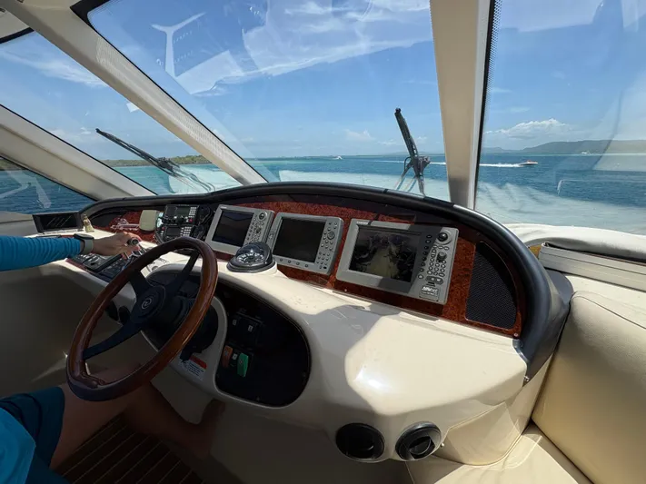 Obelix Yacht Photos Pics Helm of 2006 Riviera 60 Flybridge yacht with ocean view and navigation equipment.