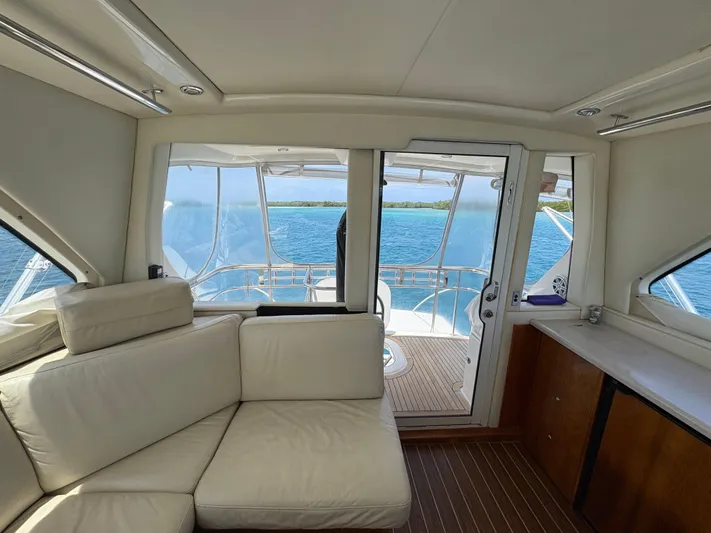 Obelix Yacht Photos Pics Interior of 2006 Riviera 60 Flybridge yacht with white seating and ocean view.
