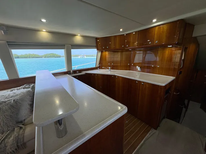 Obelix Yacht Photos Pics Luxurious interior of 2006 Riviera 60 Flybridge yacht with elegant wood finishes.