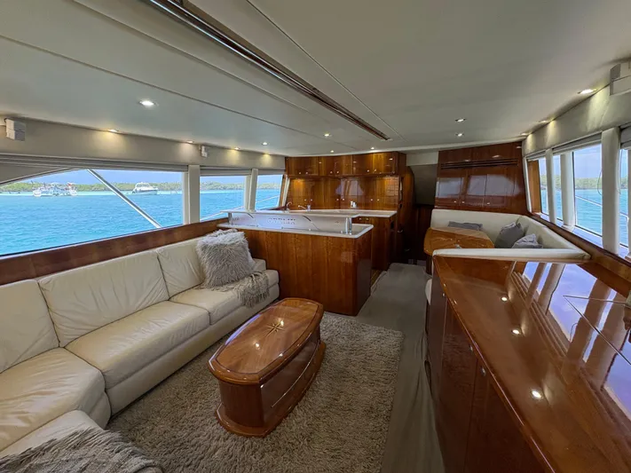 Obelix Yacht Photos Pics Luxurious interior of 2006 Riviera 60 Flybridge yacht with elegant wood finishes and ocean view.