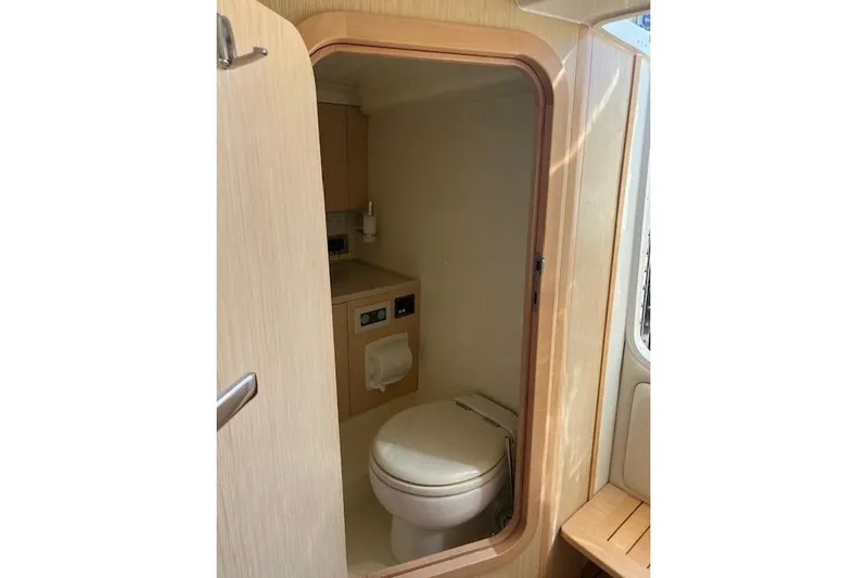  Yacht Photos Pics 2017 Chris-Craft Corsair 32 boat interior bathroom with wooden finish and compact design.