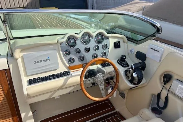  Yacht Photos Pics 2017 Chris-Craft Corsair 32 boat dashboard with Garmin navigation and wooden steering wheel.